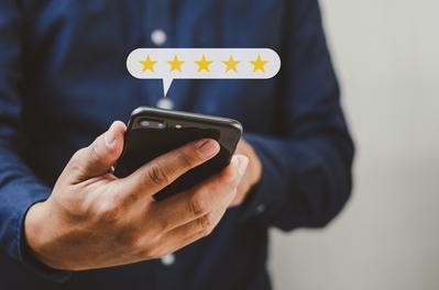 person leaving 5 star review on phone