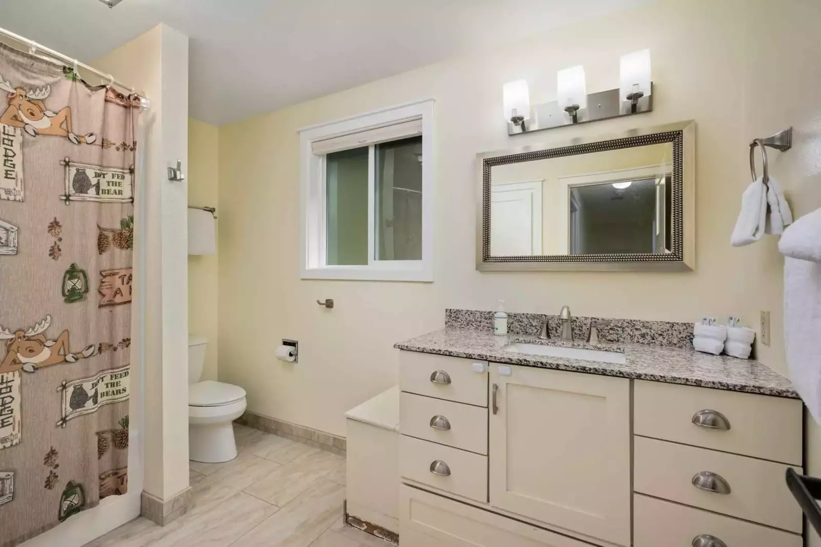 This bathroom is spacious and has a shower with excellent water pressure.