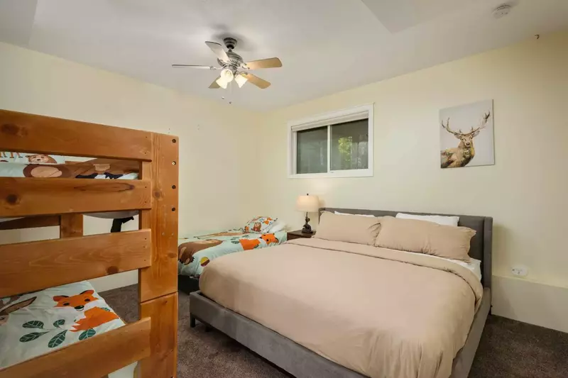 This room has a king bed, a twin bed, and a twin bunk bed,