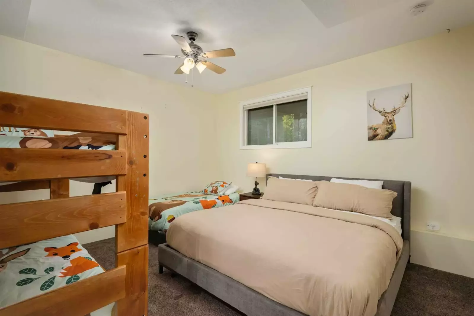 This room has a king bed, a twin bed, and a twin bunk bed,