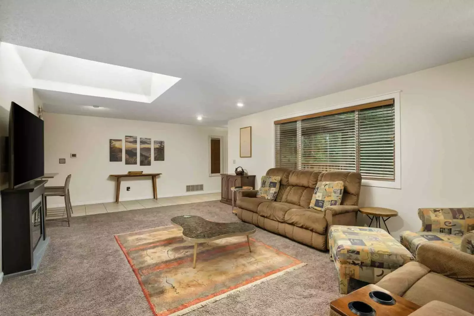 The home theatre has comfy seating and a large flat screen tv.