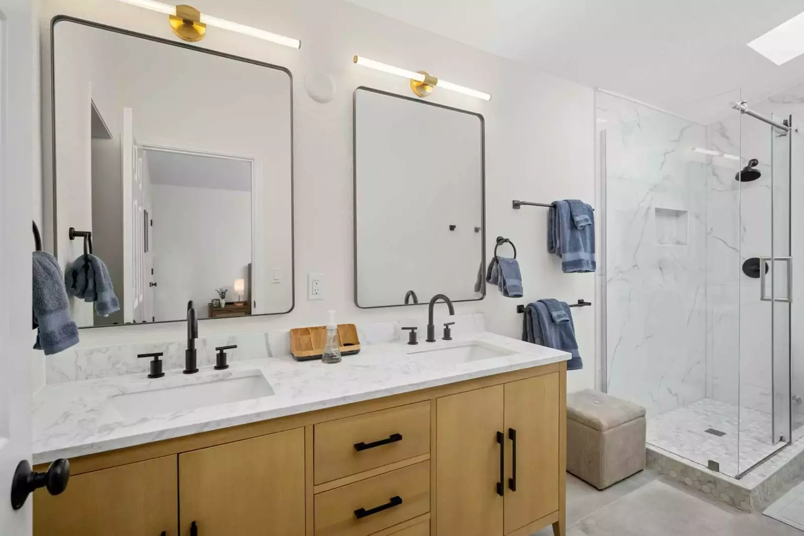 This bathroom has two sinks and a shower with excellent water pressure.