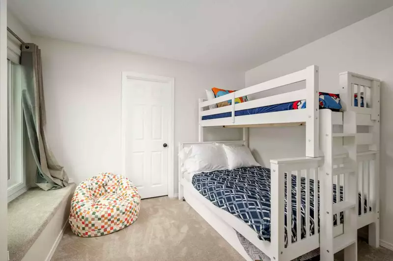 This room has three beds and a smart tv.