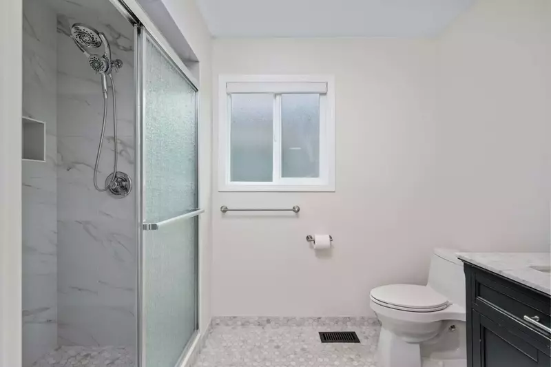 Another bathroom featuring a shower with robust water pressure.