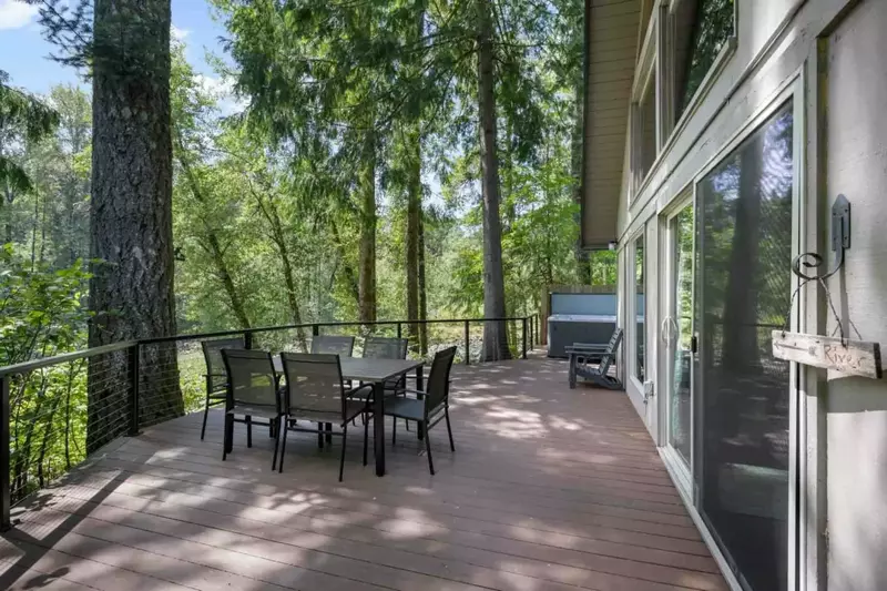 The deck is a perfect place to hang out and enjoy the forest and river view.