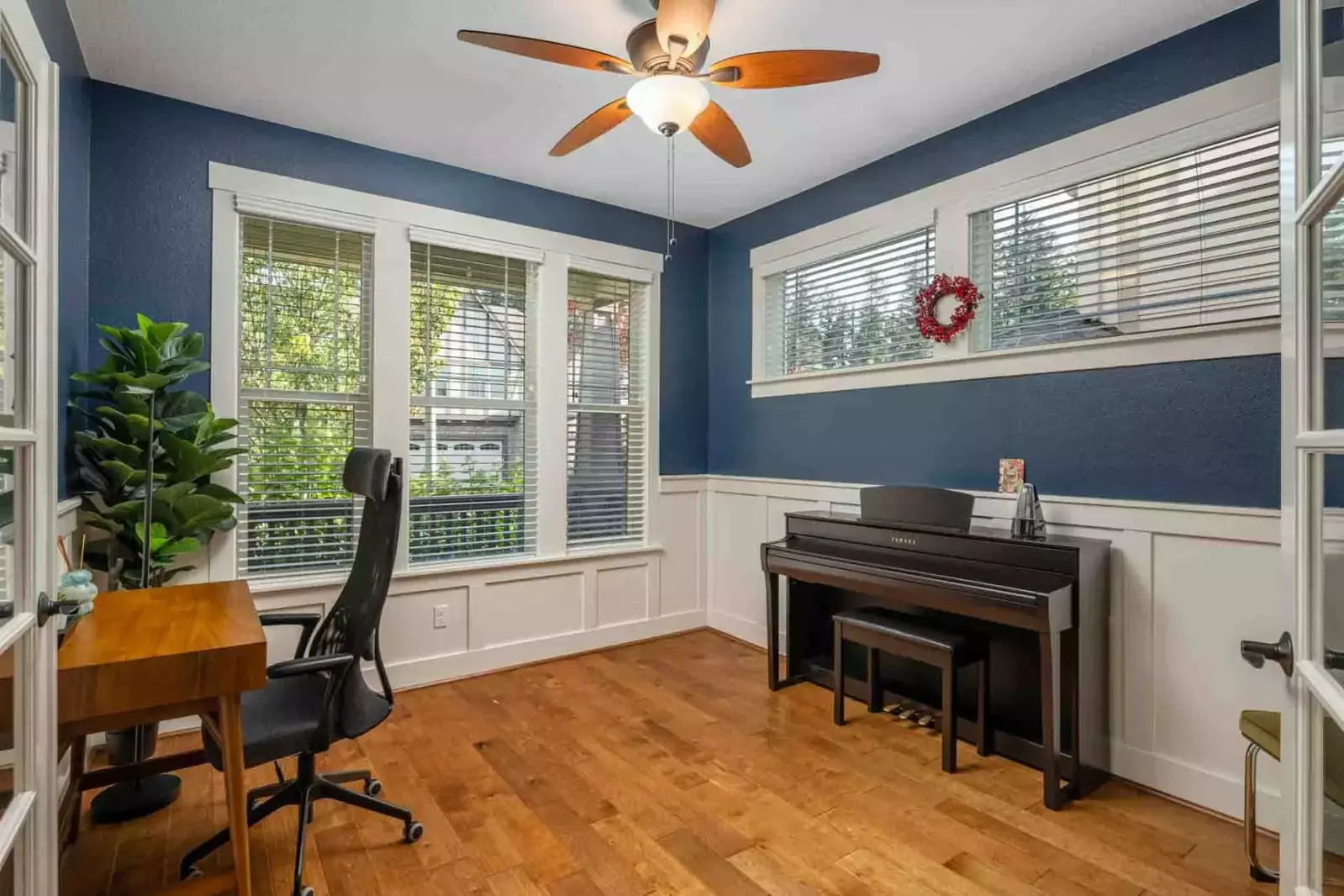 The home office also includes a small piano.