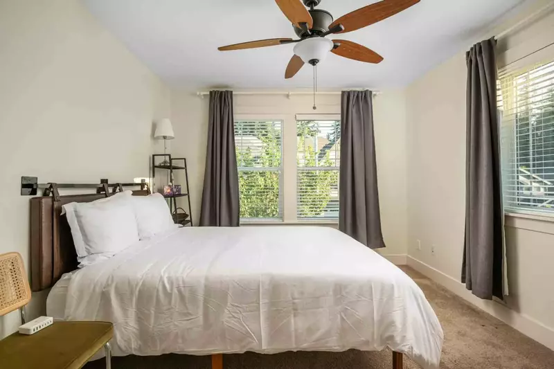 Another comfortable bed with a ceiling fan.