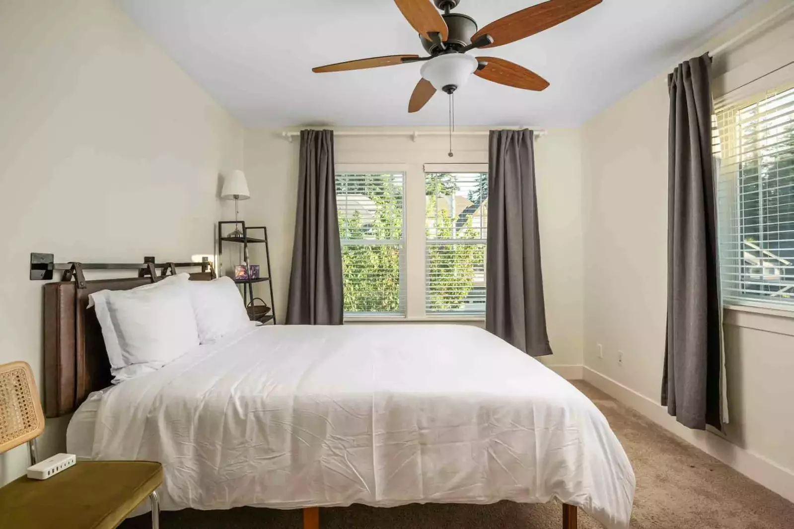 Another comfortable bed with a ceiling fan.