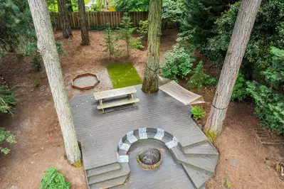 Enjoy the gorgeous and uniquely designed yard at Cozy River Forest Retreat.
