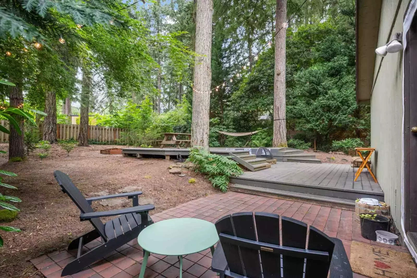 The yard has towering trees making it feel like a woodland getaway.