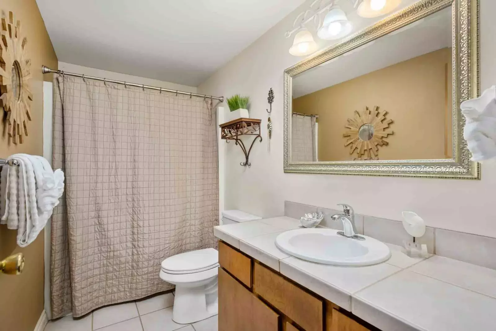 The bathroom is recently updated and ornately decorated.