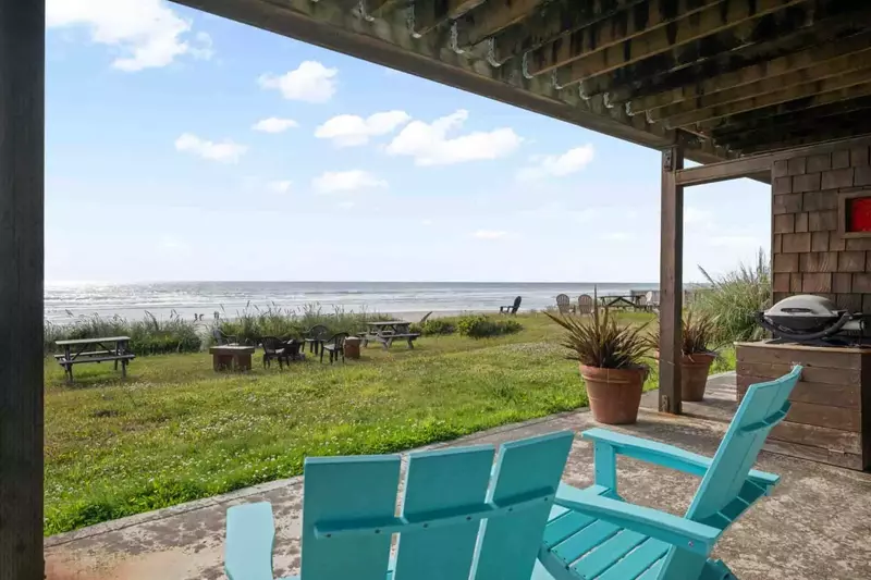 Enjoy a view of the beach and Twin Rocks from the beachfront yard.