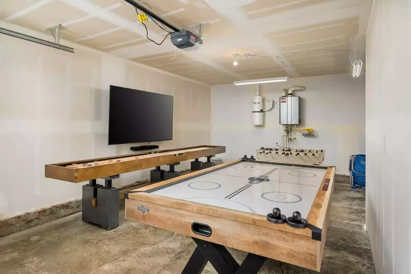 The game room is full of activities like shuffleboard, air hockey, foosball, a tv, and more!