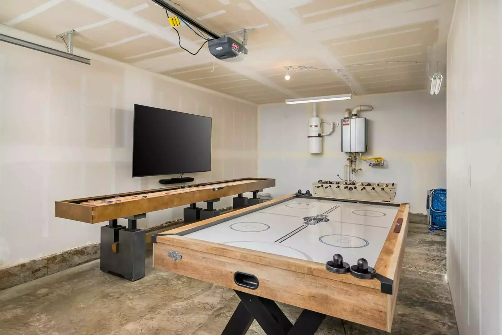 The game room is full of activities like shuffleboard, air hockey, foosball, a tv, and more!