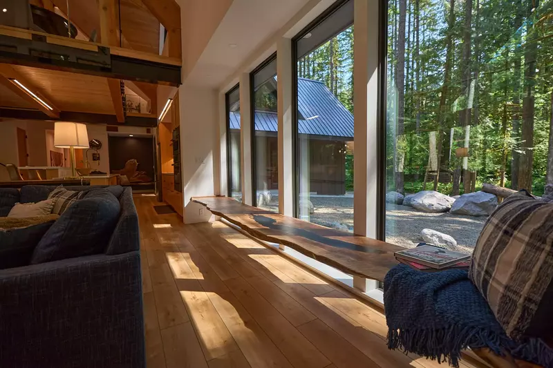 Spotted Dog Lodge has massive windows with excellent views of the mountain forest.