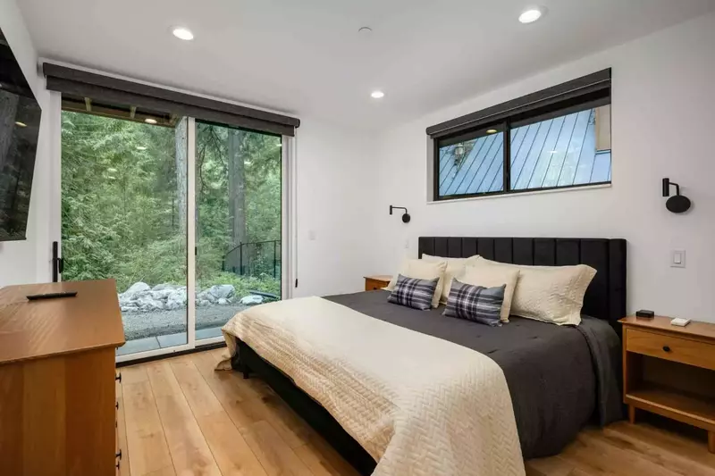 This room has a comfy bed, smart tv, and gorgeous forest view.