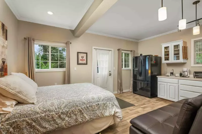 This bedroom has a fridge and kitchenette.