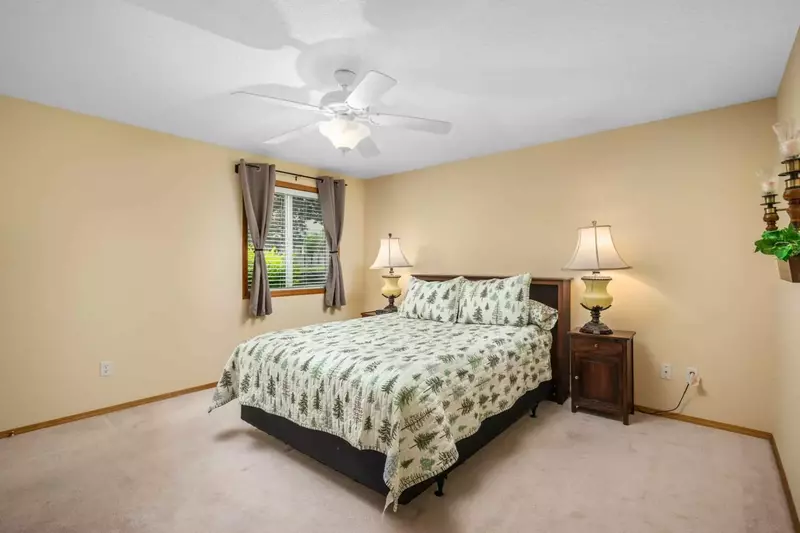 Another comfortable bed with a ceiling fan.