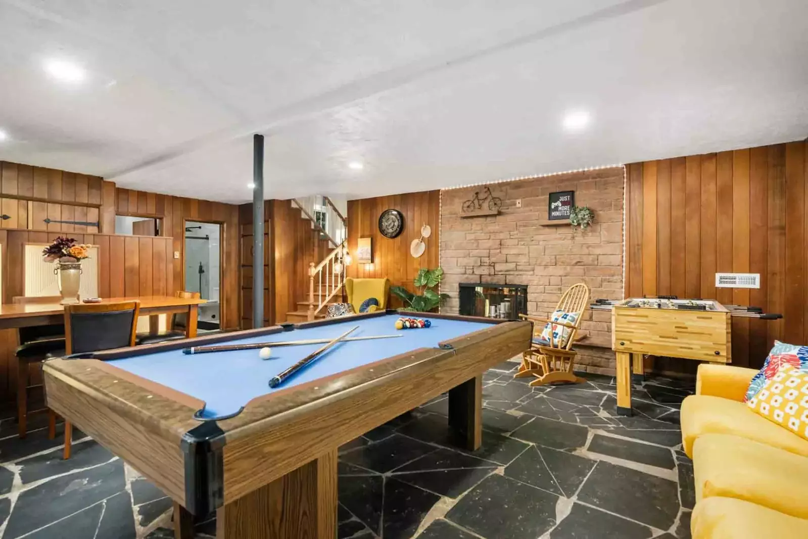 The game room includes a pool table, foosball table, dartboard, and more.
