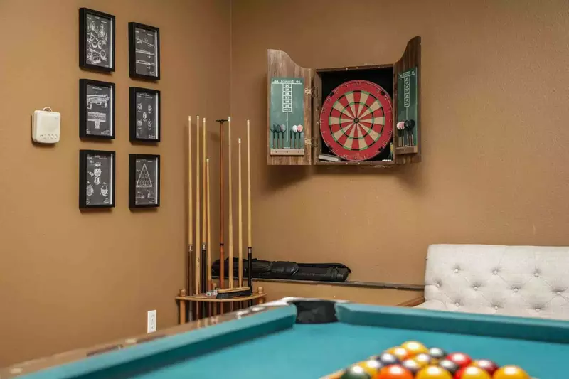 A dart board with darts for guest enjoyment.