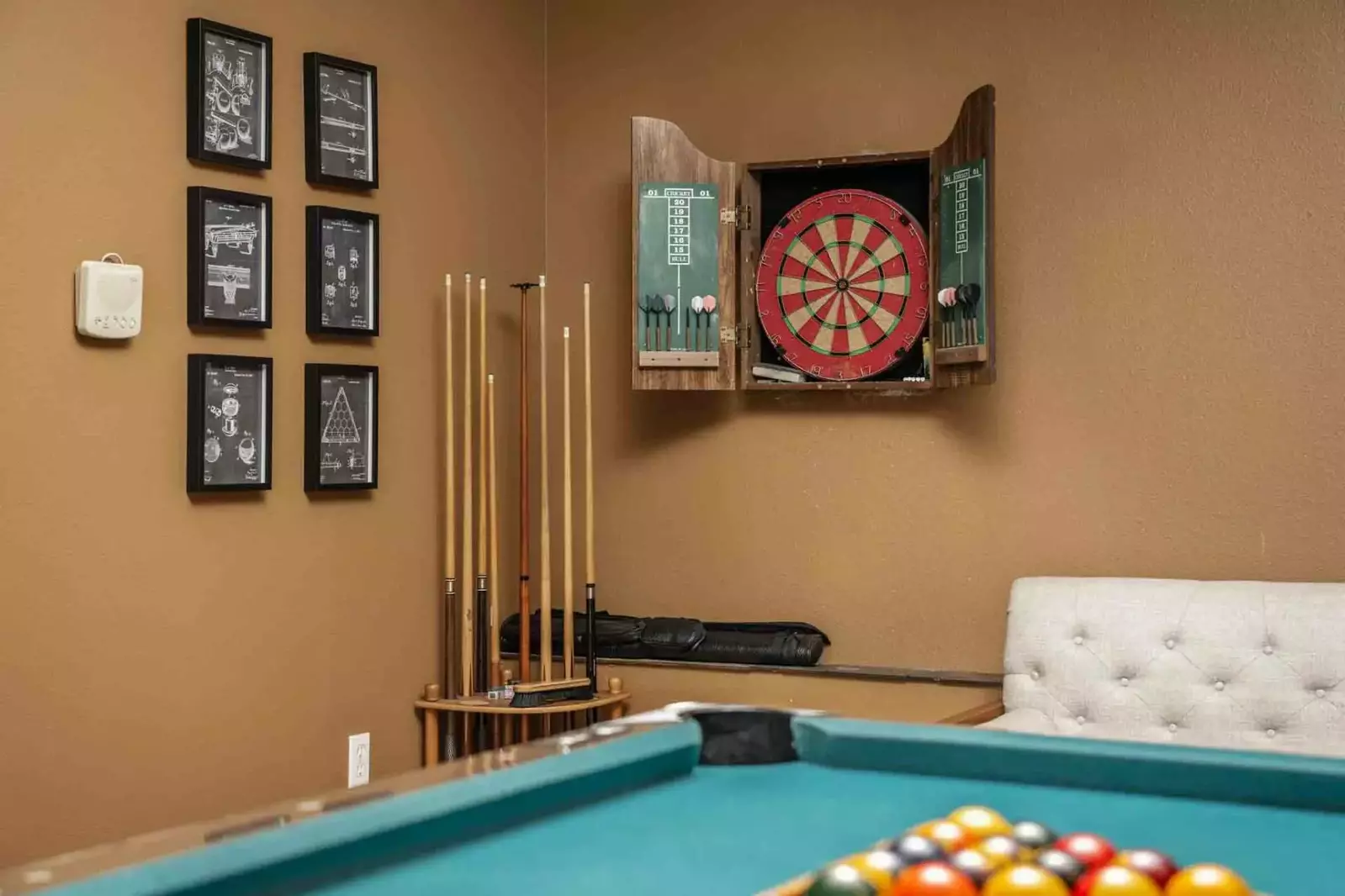 A dart board with darts for guest enjoyment.