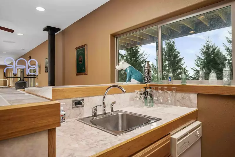 The game room has a mini bar with a sink and dishwasher.