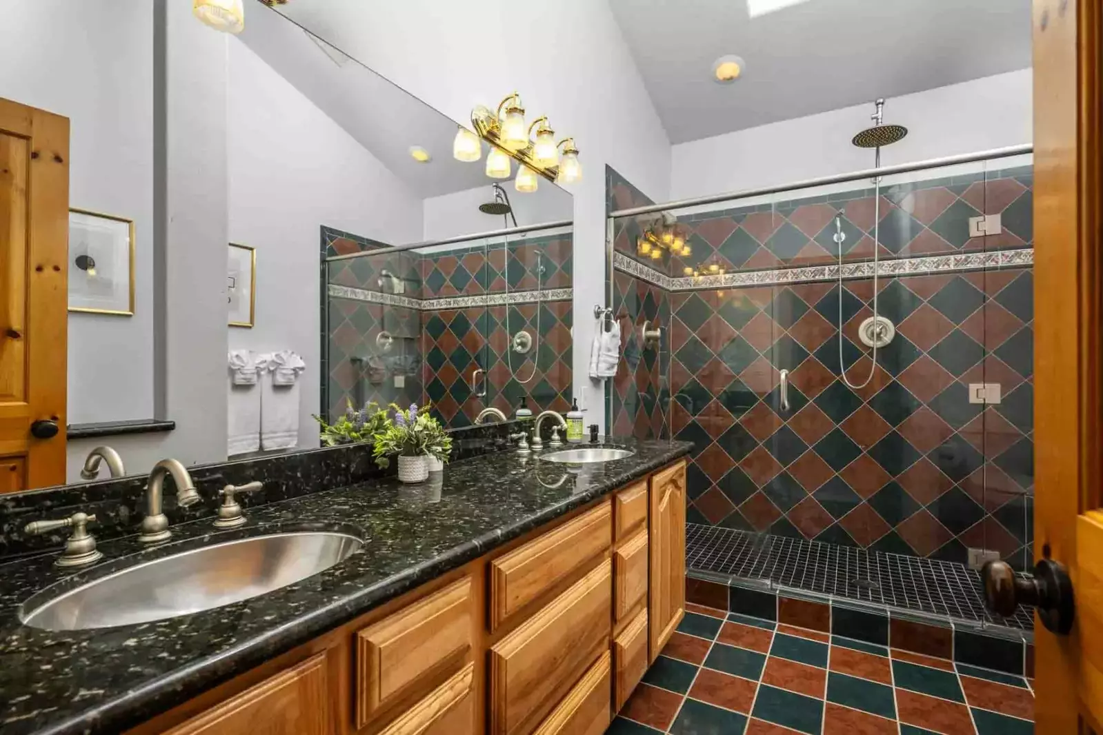 This bathroom has two sinks and a shower with excellent water pressure.