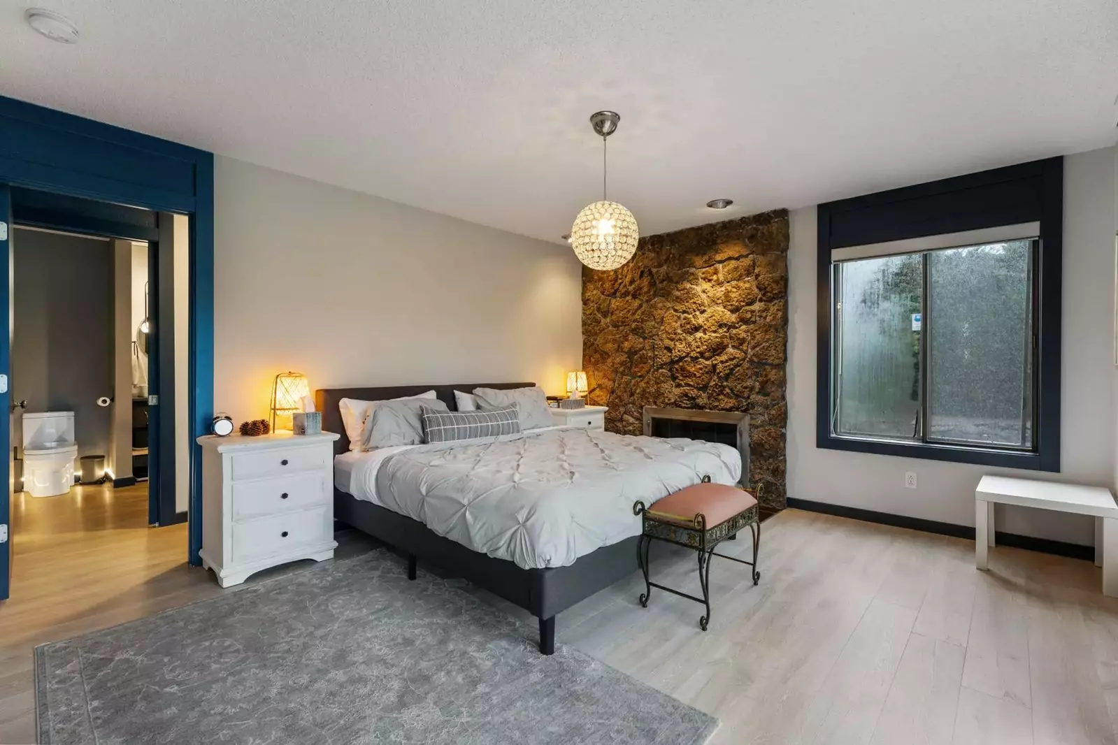 This bedroom is spacious with an incredibly comfortable bed.