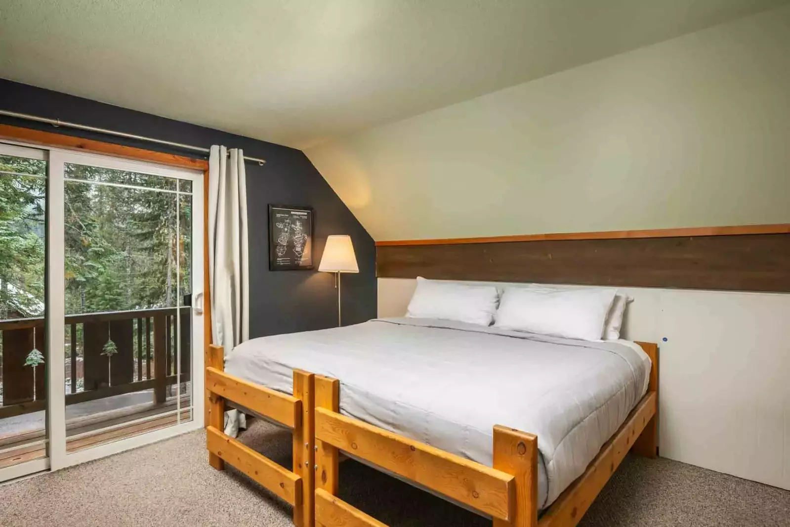 Relax in your comfy bed with great forest views.