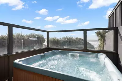 Multiple decks, including a wind-screened hot tub.