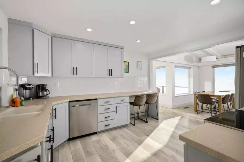 The open-layout kitchen features luxurious stainless steel appliances, making it a dream for cooking and gathering with loved ones.