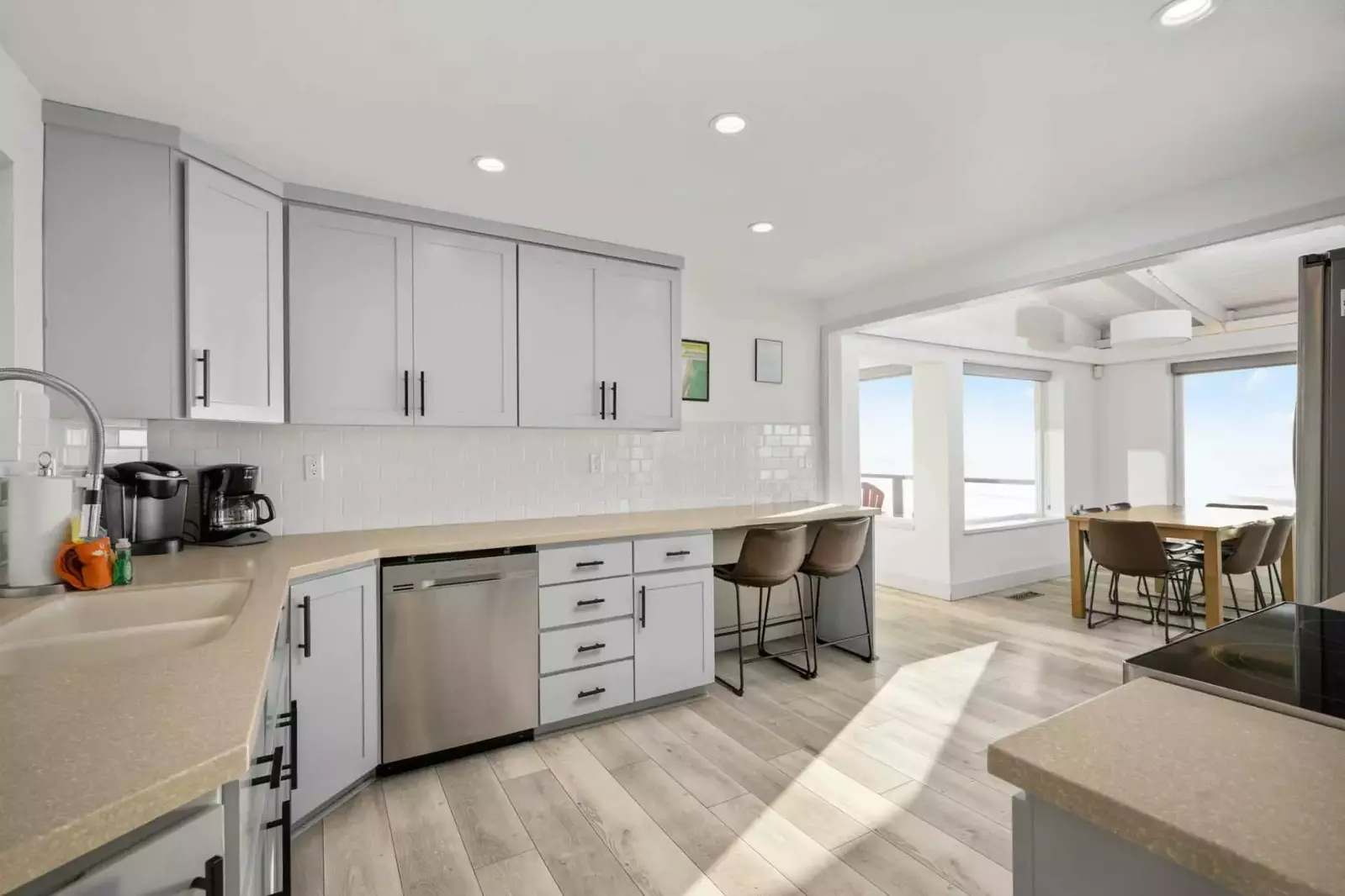 The open-layout kitchen features luxurious stainless steel appliances, making it a dream for cooking and gathering with loved ones.