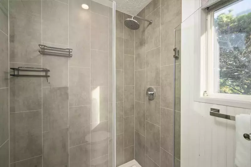 The shower is spacious, up to date, and has excellent water pressure.