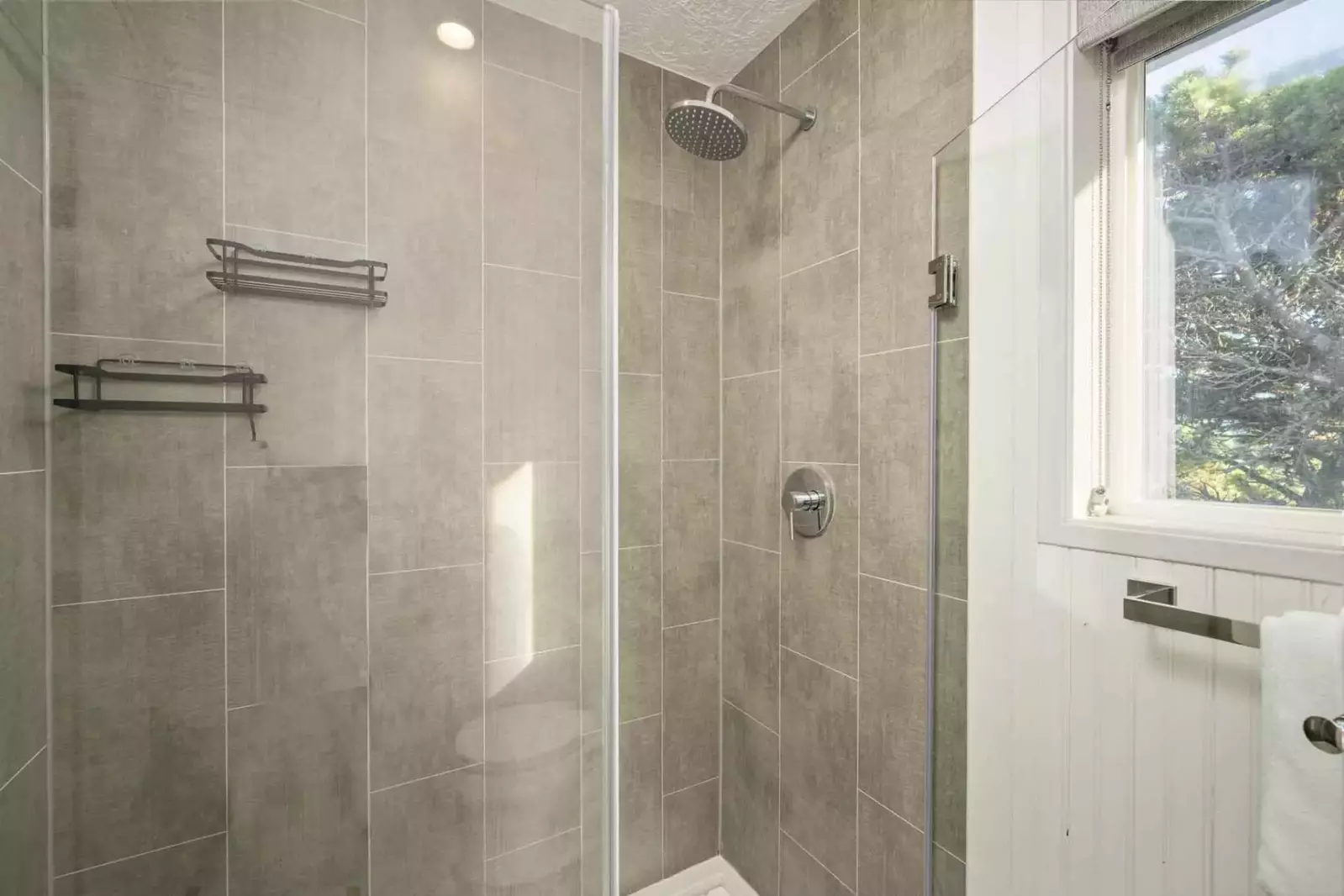 The shower is spacious, up to date, and has excellent water pressure.
