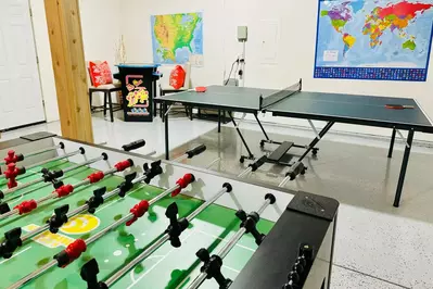 The fun continues in the converted garage game room, where you’ll find a ping pong & foosball table along with multiple game arcade system, providing