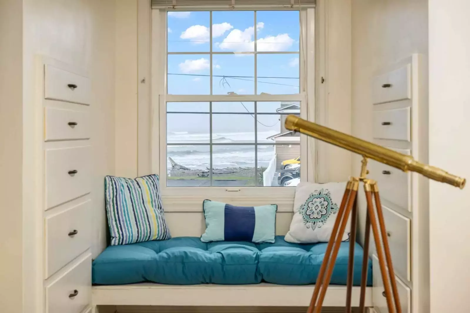 Cozy details like a window seat tucked into an upstairs dormer and TVs in the bedrooms add an extra touch of relaxation and charm.