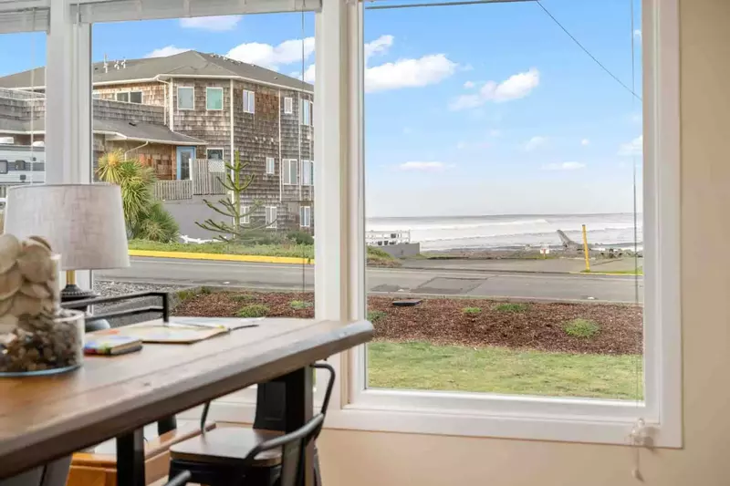 Large ocean-view windows in the living and dining areas provide a stunning backdrop.