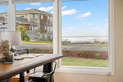 Large ocean-view windows in the living and dining areas provide a stunning backdrop.