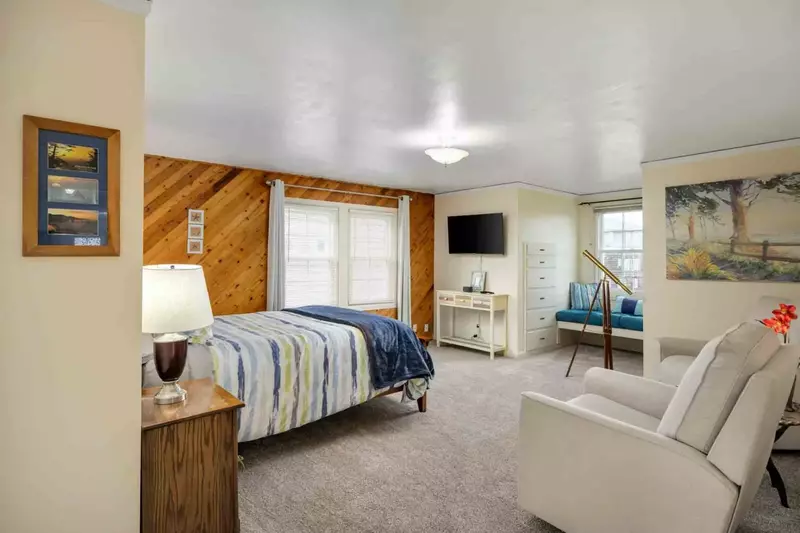 This bedroom is incredibly spacious, with a comfy bed, smart tv, telescope, and more.