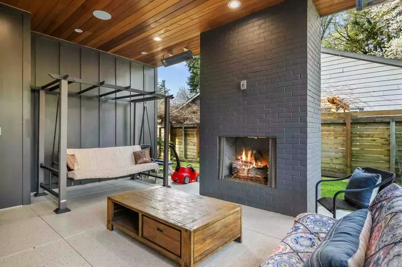 Get comfy in the swinging couch in front of the fireplace.