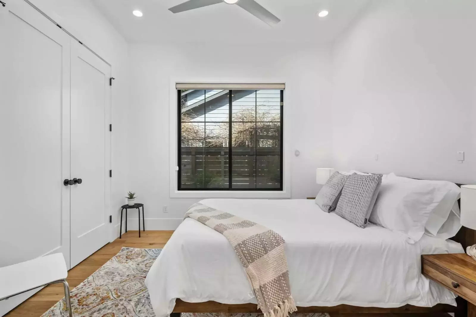 Another comfortable bed with in a large room.