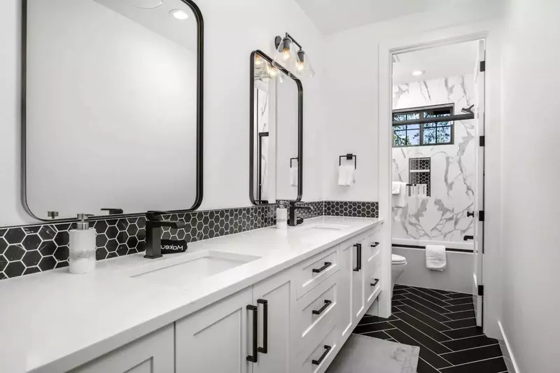 Another bathroom featuring two sinks and a shower with robust water pressure.