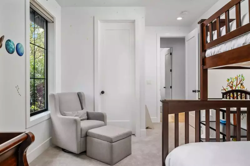 The bunk room also features a crib and a changing table.