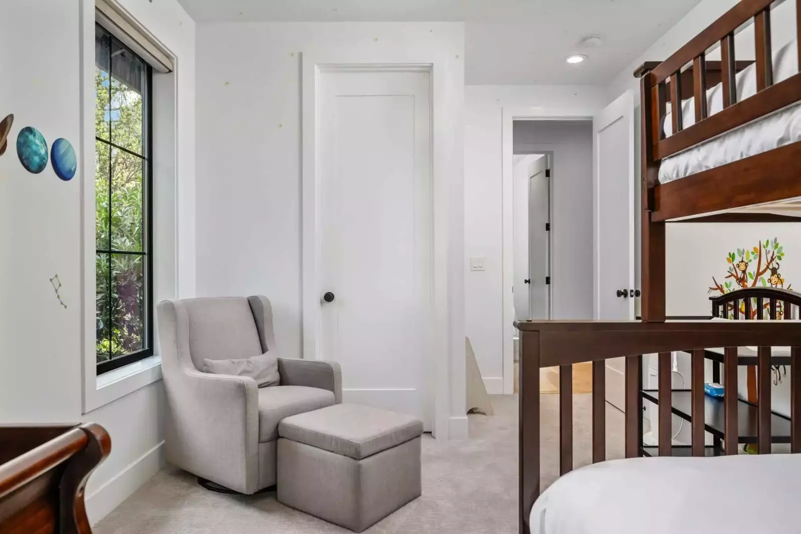 The bunk room also features a crib and a changing table.