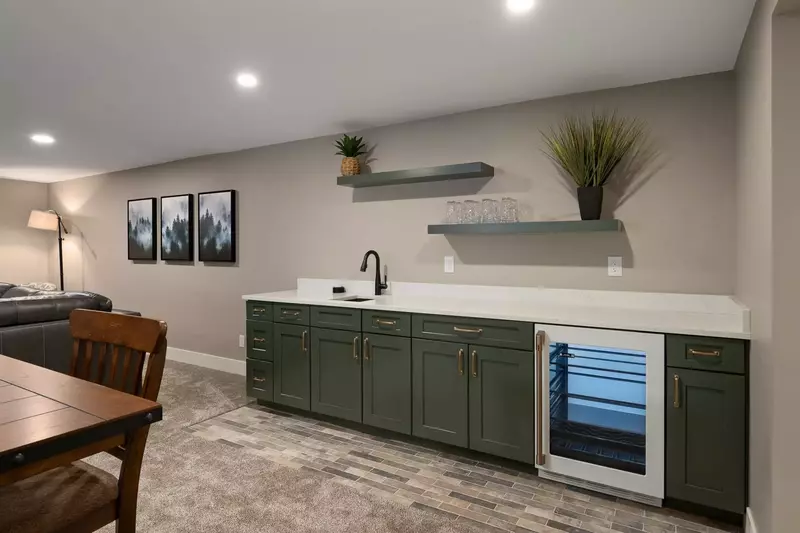 The room has a mini bar with a mini fridge and sink.