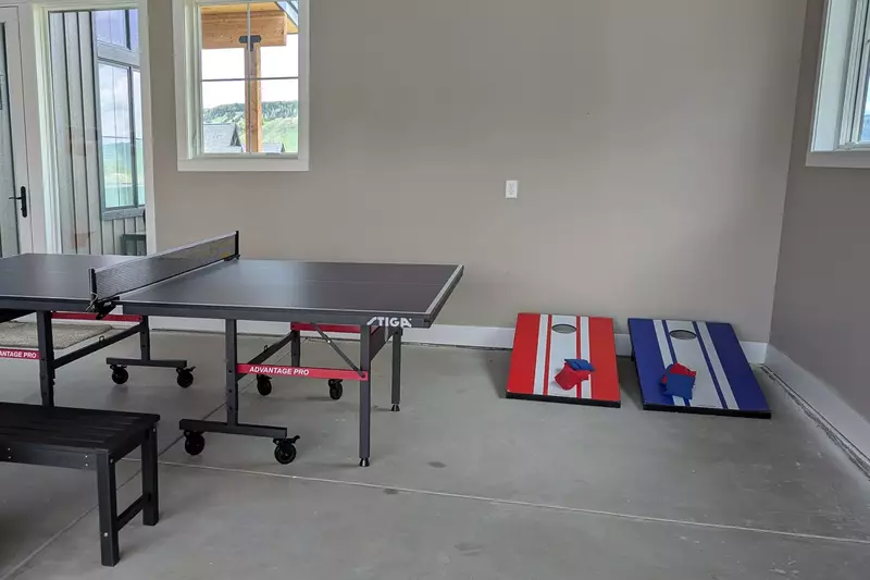 Garage includes a ping pong table, Jenga blocks and cornhole.