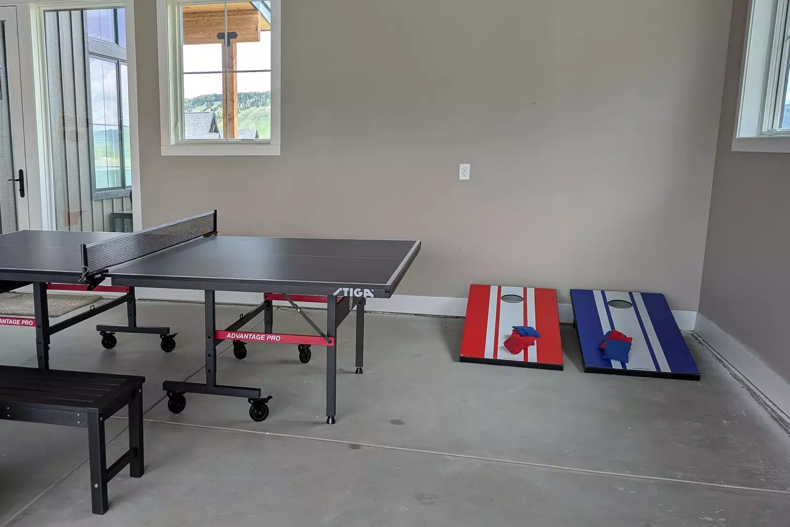 Garage includes a ping pong table, Jenga blocks and cornhole.