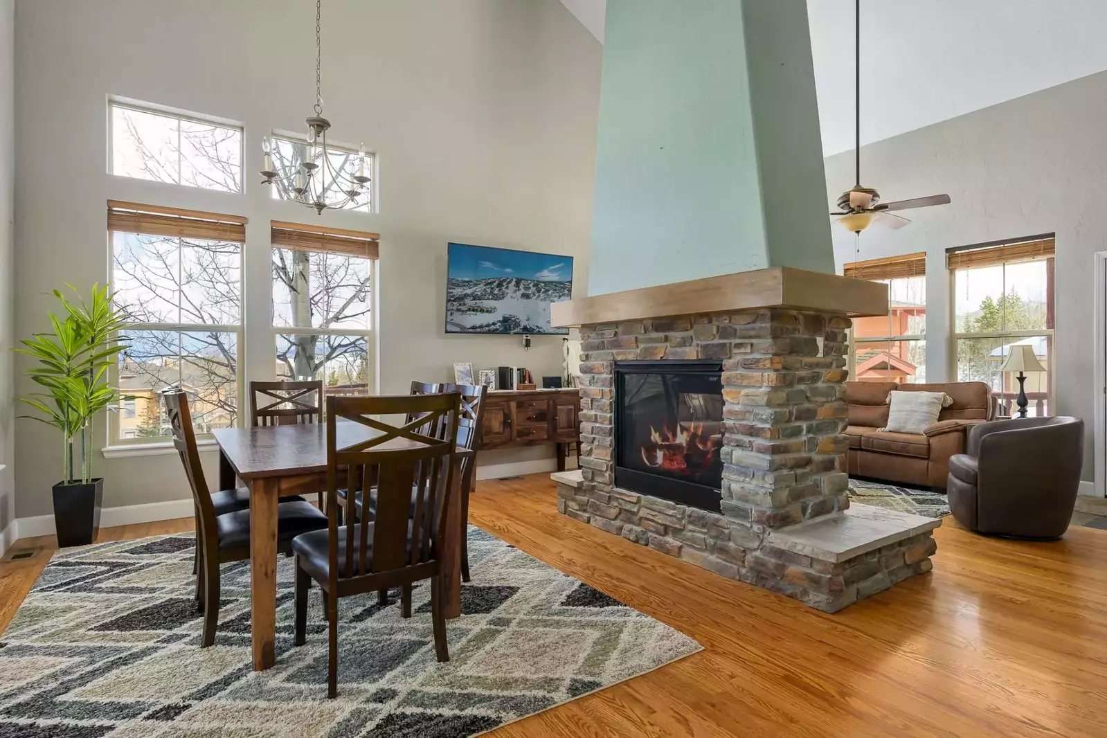 The fireplace is a dual-side fireplace. Enjoy on the couch and at the dining table.