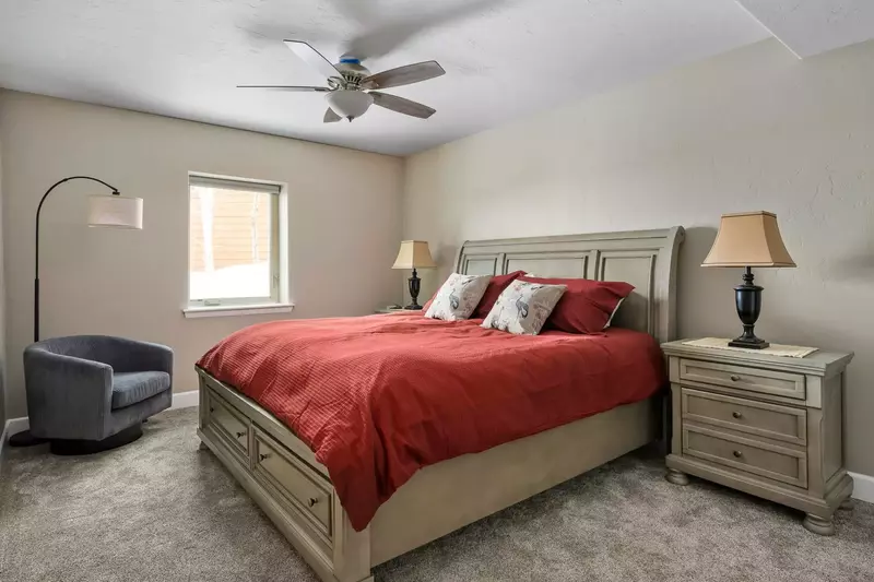 Another spacious bedroom with a ceiling fan.