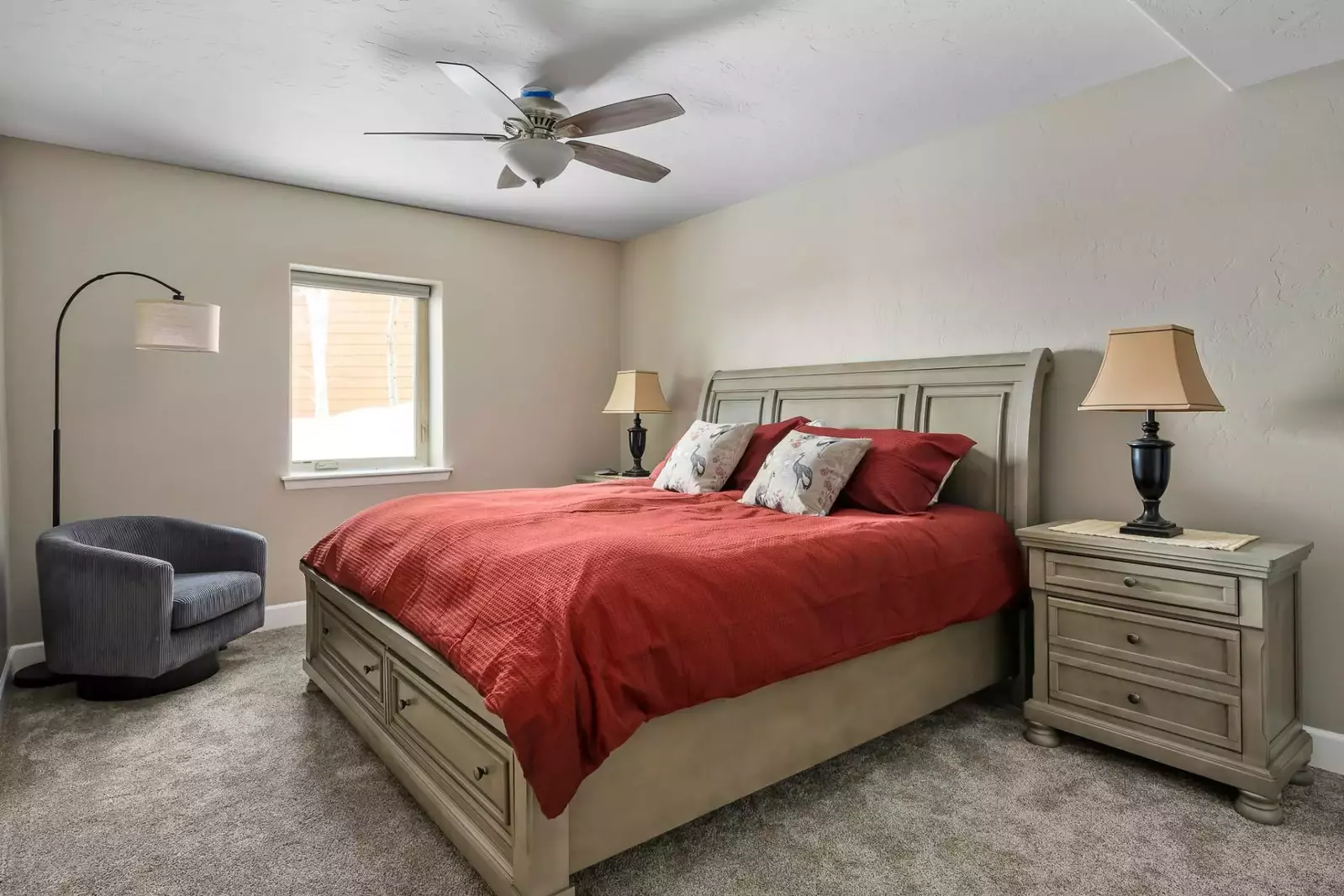 Another spacious bedroom with a ceiling fan.